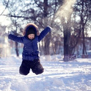 Kid jumping in snow